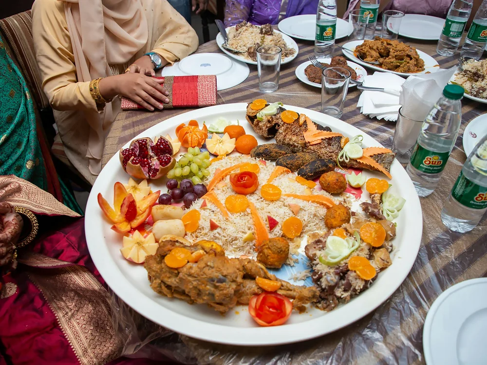 A large plate of food set on a wooden table